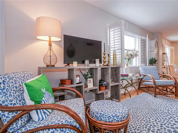 a view of a porch with chairs and potted plants