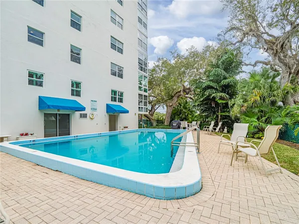 a view of swimming pool with outdoor seating