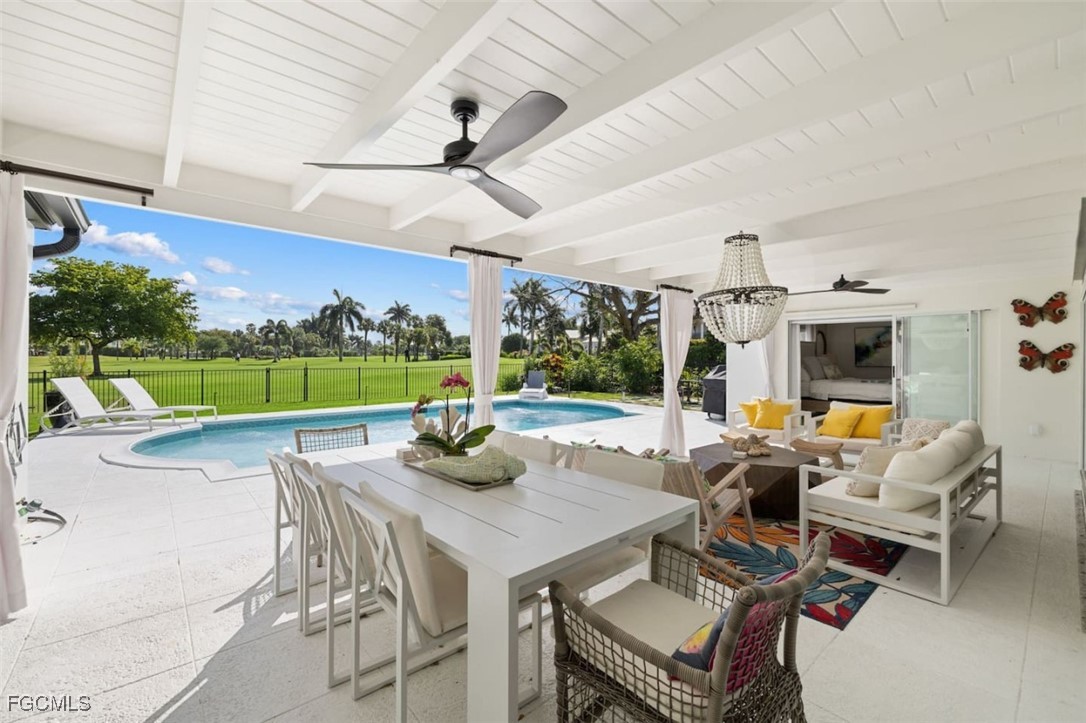 2728 Crayton Road Naples, FL 34103 - Photo 13 of 35 a view of a patio with a dining table and chairs