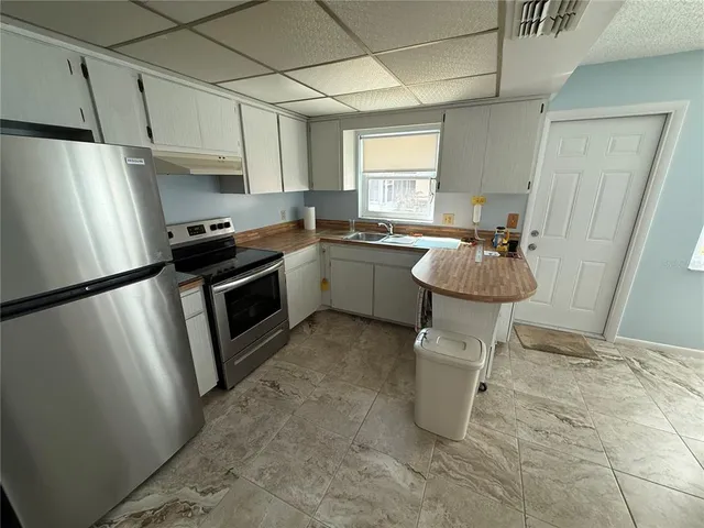 a kitchen with a sink appliances and cabinets