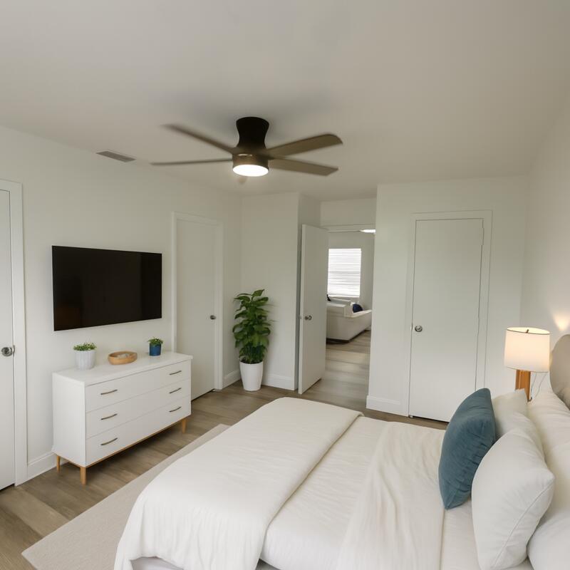 5231 Wallis Road, Unit C West Palm Beach, FL 33415 - Photo 3 of 8 a bedroom with a bed and a flat screen tv