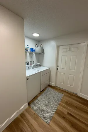 a kitchen with a sink cabinets and a wooden floor