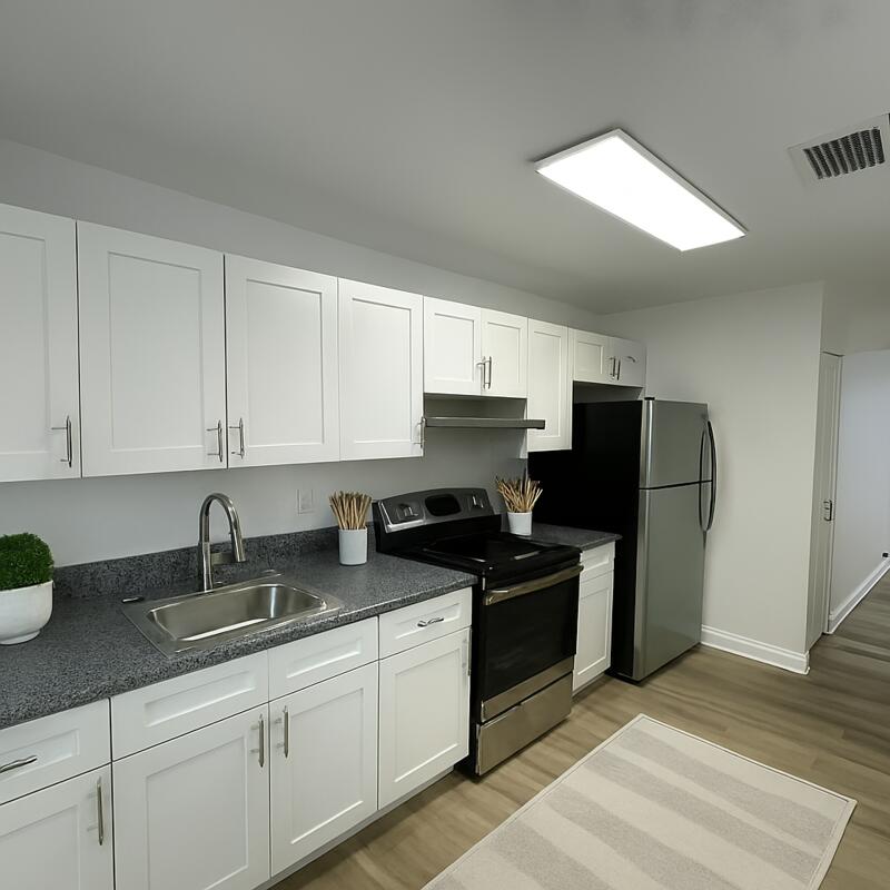 5231 Wallis Road, Unit C West Palm Beach, FL 33415 - Photo 5 of 8 a kitchen with stainless steel appliances granite countertop a sink stove and refrigerator