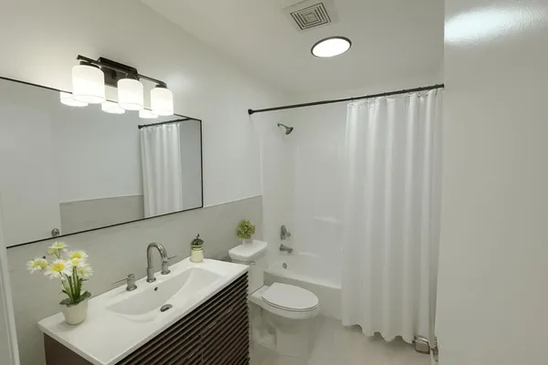 a bathroom with a sink toilet and shower