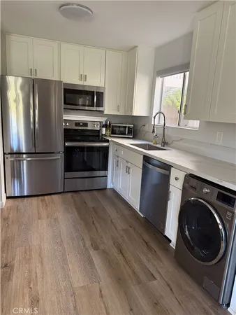 a kitchen with wooden cabinets and stainless steel appliances