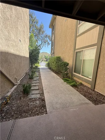 a view of a pathway of a house with a street