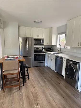a kitchen with kitchen island a stove a sink and a refrigerator