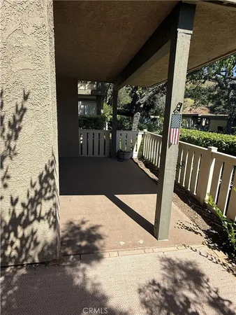 a view of a porch with wooden floor