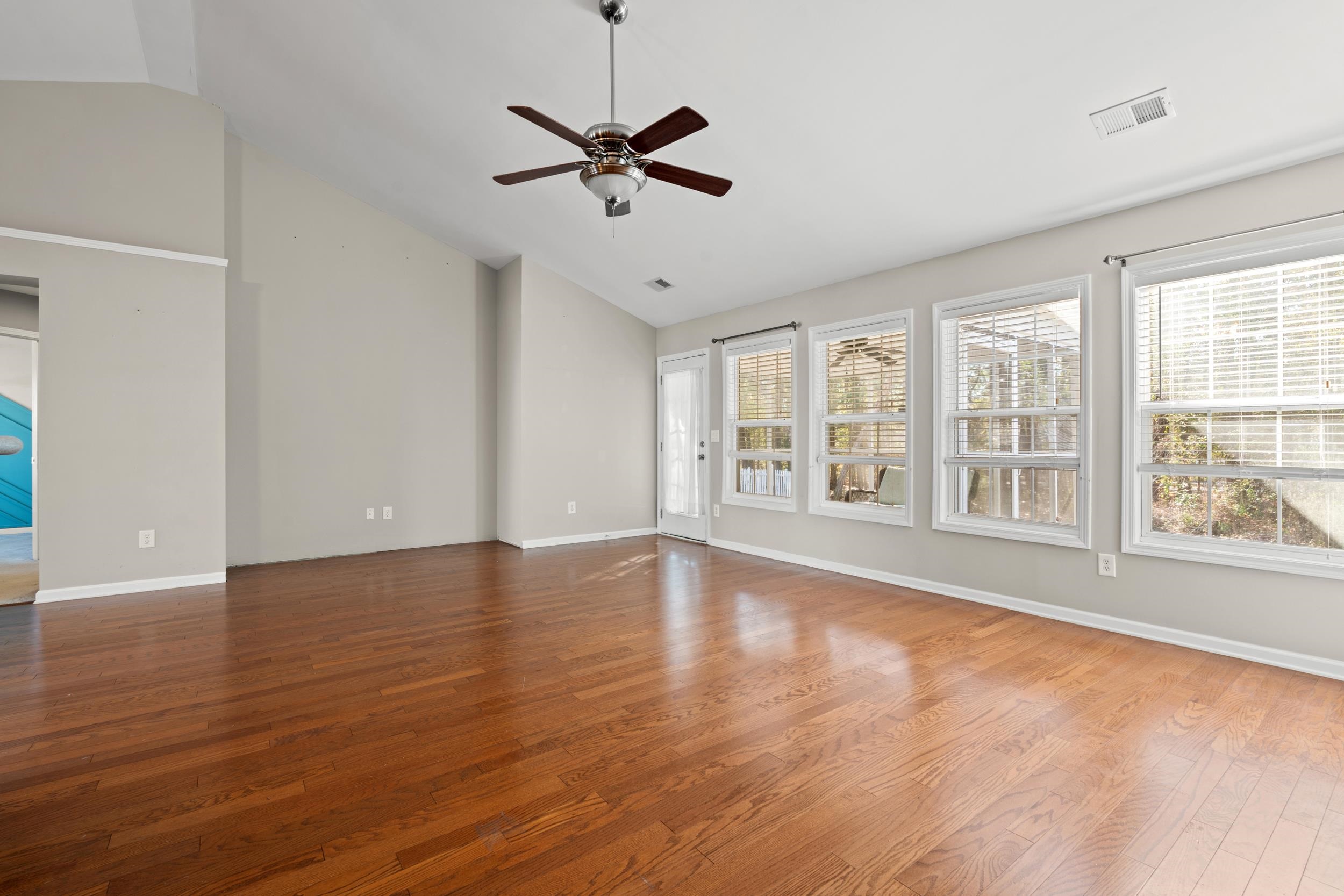 2487 Windmill Way Myrtle Beach, SC 29579 - Photo 11 of 40 Spare room featuring wood finished floors, a ceiling fan, and high vaulted ceiling
