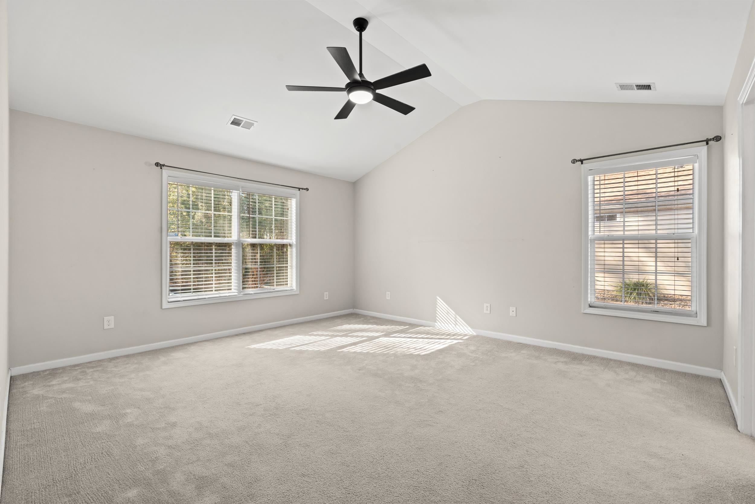 2487 Windmill Way Myrtle Beach, SC 29579 - Photo 18 of 40 Carpeted spare room featuring vaulted ceiling and ceiling fan