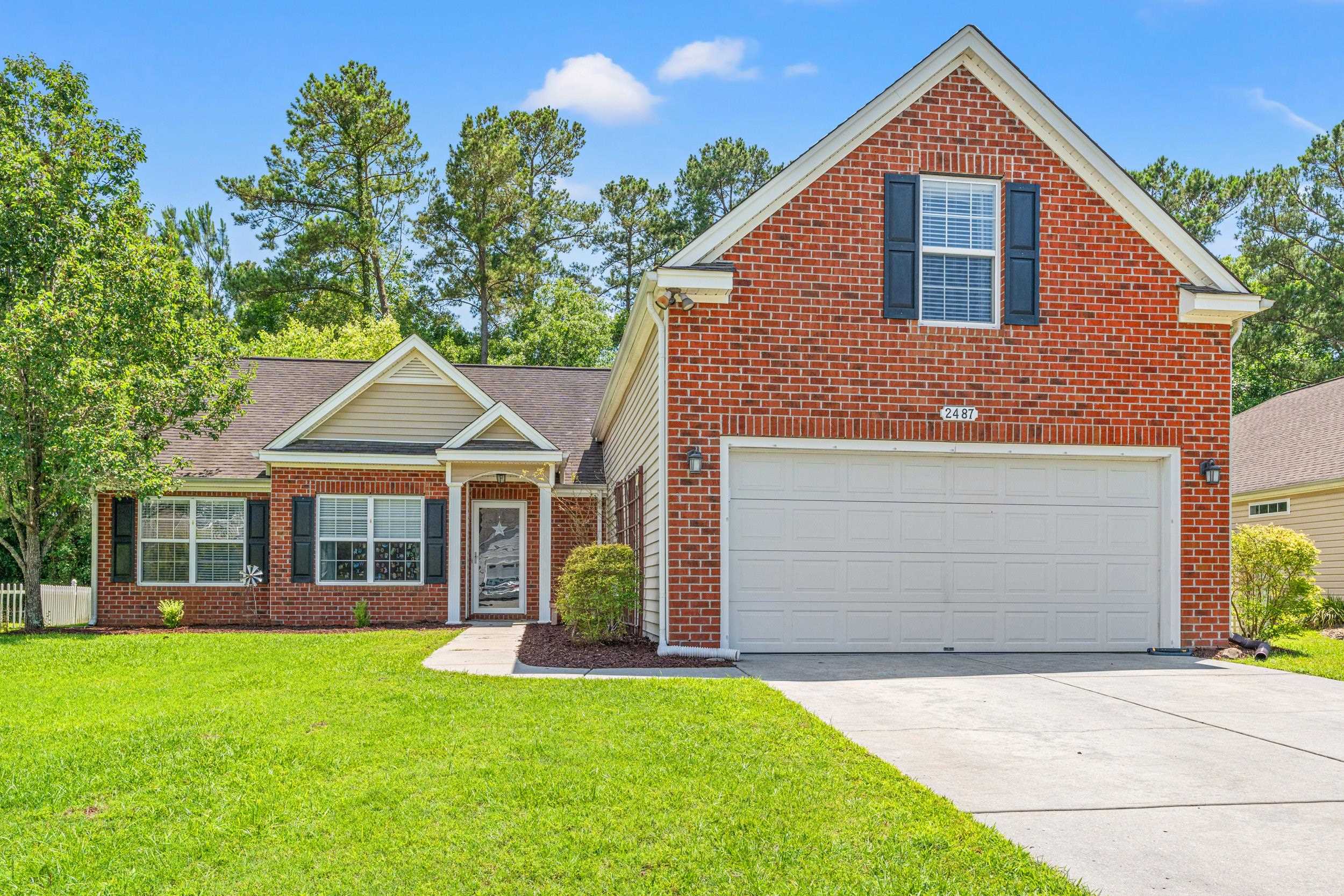 2487 Windmill Way Myrtle Beach, SC 29579 - Photo 2 of 40 Traditional home with a front yard, concrete driveway, and brick siding