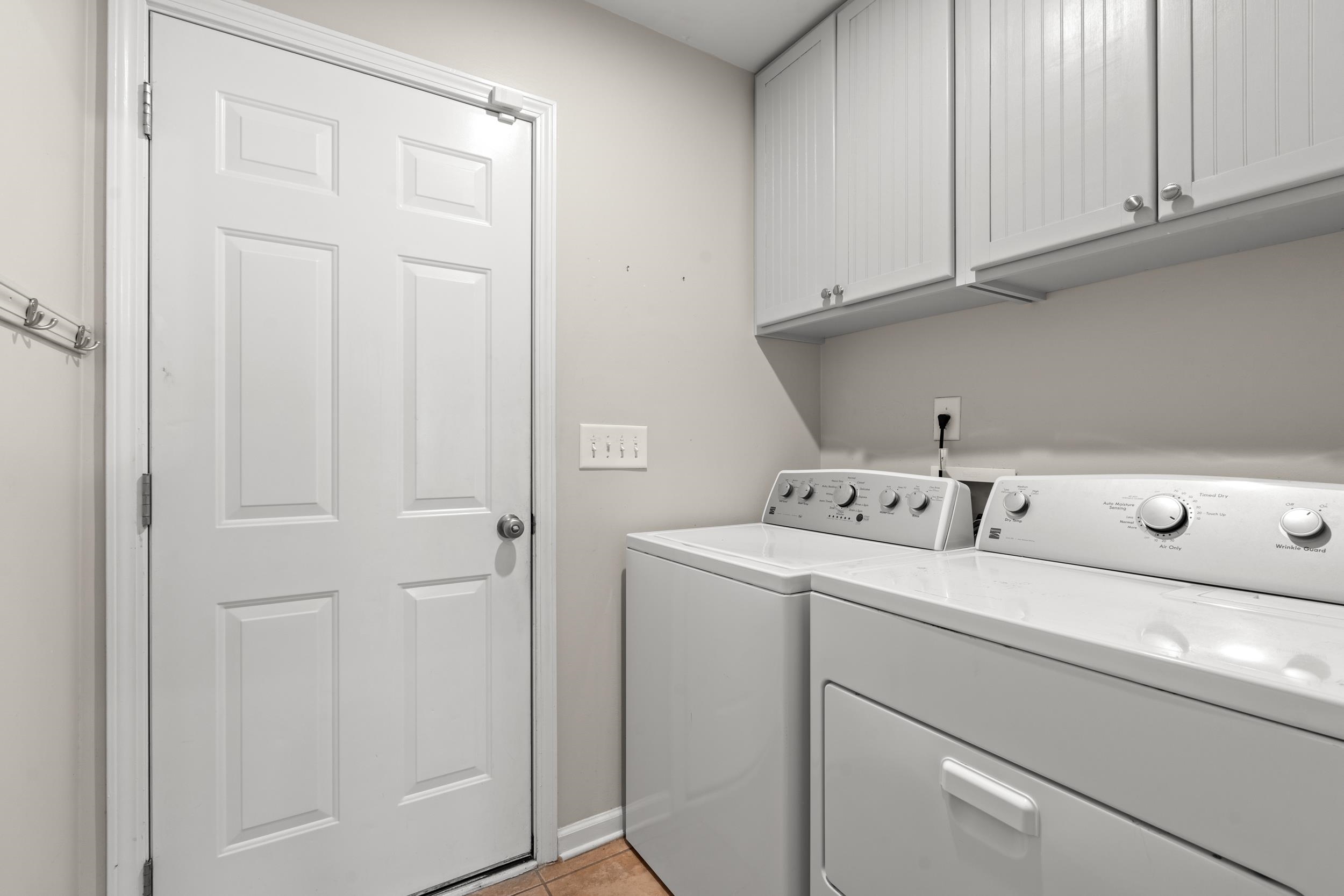 2487 Windmill Way Myrtle Beach, SC 29579 - Photo 30 of 40 Washroom featuring cabinet space, washing machine and clothes dryer, and light tile patterned floors