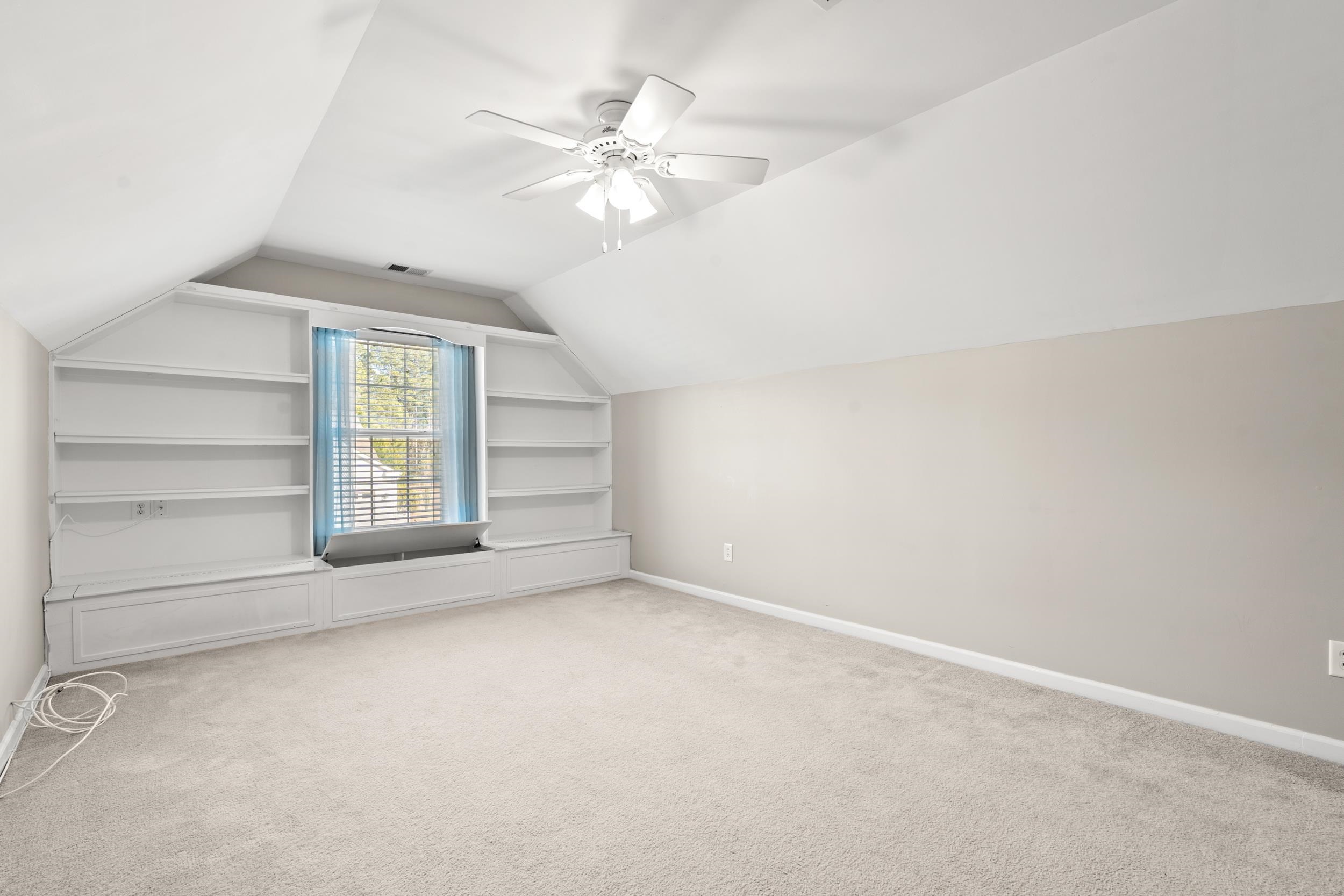 2487 Windmill Way Myrtle Beach, SC 29579 - Photo 33 of 40 Bonus room featuring built in shelves, vaulted ceiling, light colored carpet, and a ceiling fan
