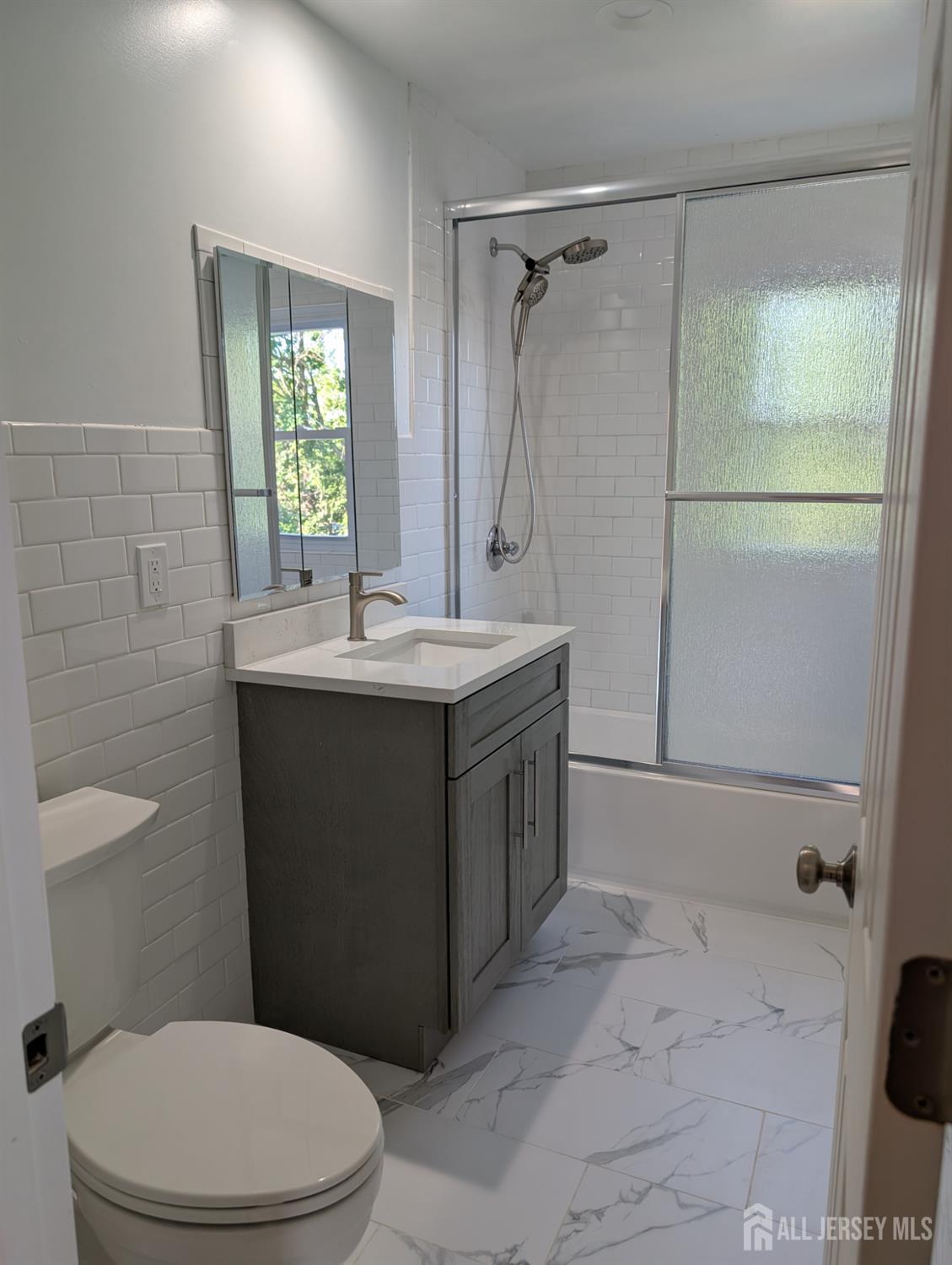 76 Glenville Road, Unit 76 Edison, NJ 08817 - Photo 11 of 13 a bathroom with a sink a toilet and shower