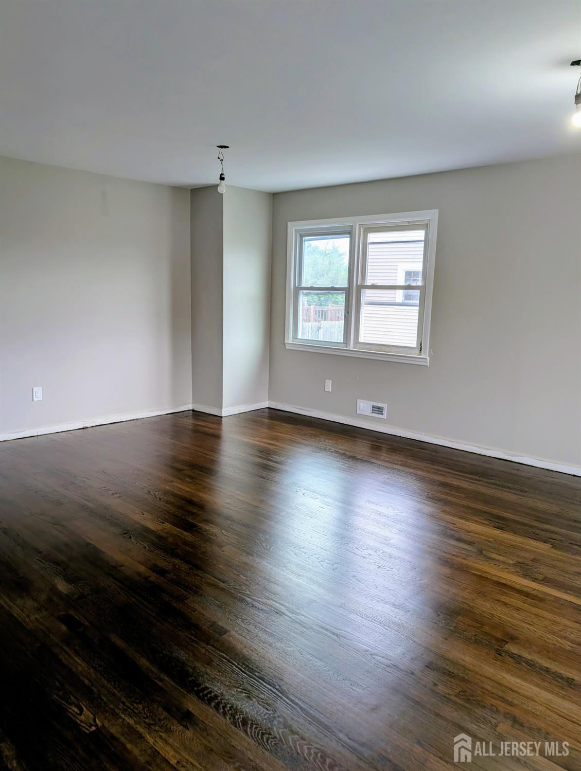 76 Glenville Road, Unit 76 Edison, NJ 08817 - Photo 3 of 13 an empty room with wooden floor and windows