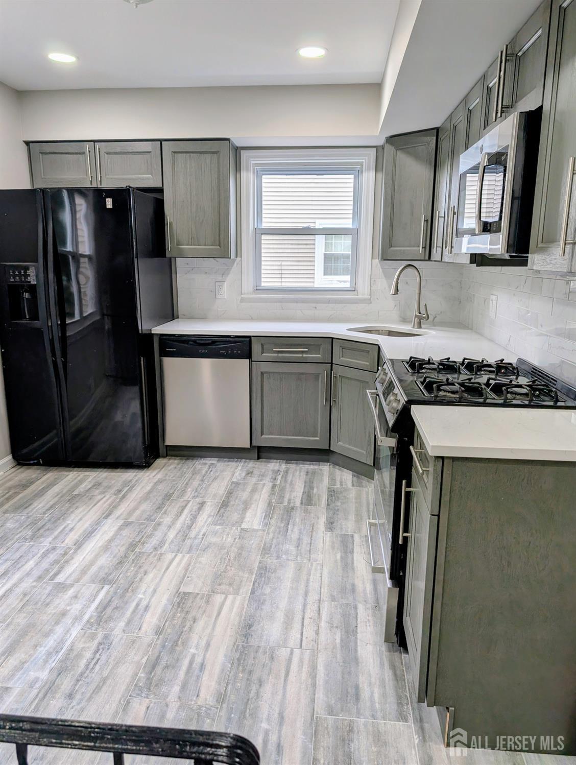 76 Glenville Road, Unit 76 Edison, NJ 08817 - Photo 4 of 13 a kitchen with stainless steel appliances a refrigerator sink and wooden cabinets