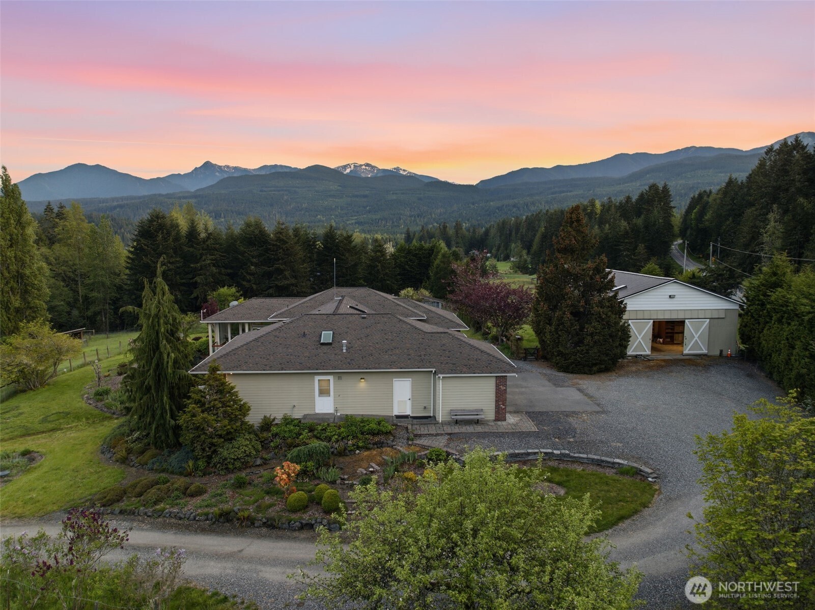 2263 Lost Mountain Road Sequim, WA 98382 - Photo 32 of 40 a front view of a house with a yard and a car park