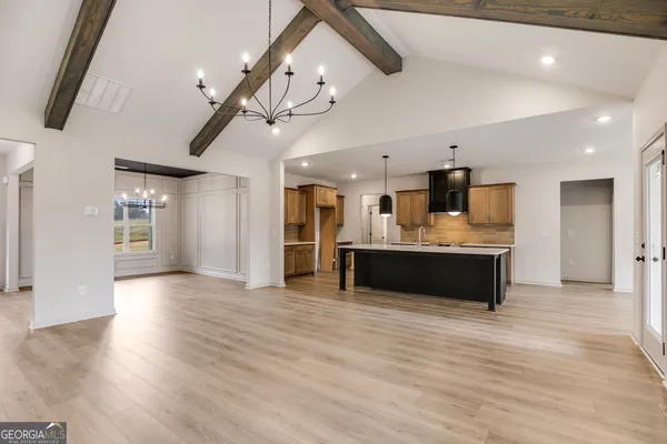 a view of a kitchen with a sink a refrigerator and window