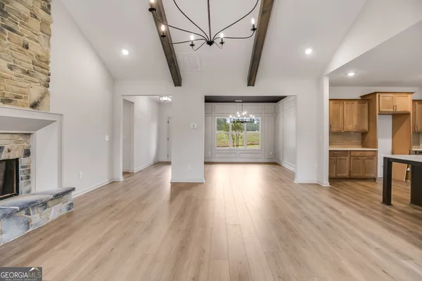 a kitchen with kitchen island white cabinets and stainless steel appliances