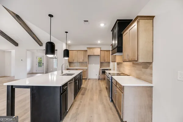 a kitchen with a sink stove and refrigerator
