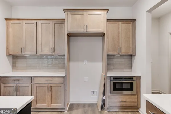 a kitchen with stainless steel appliances granite countertop a sink a stove and a wooden floors