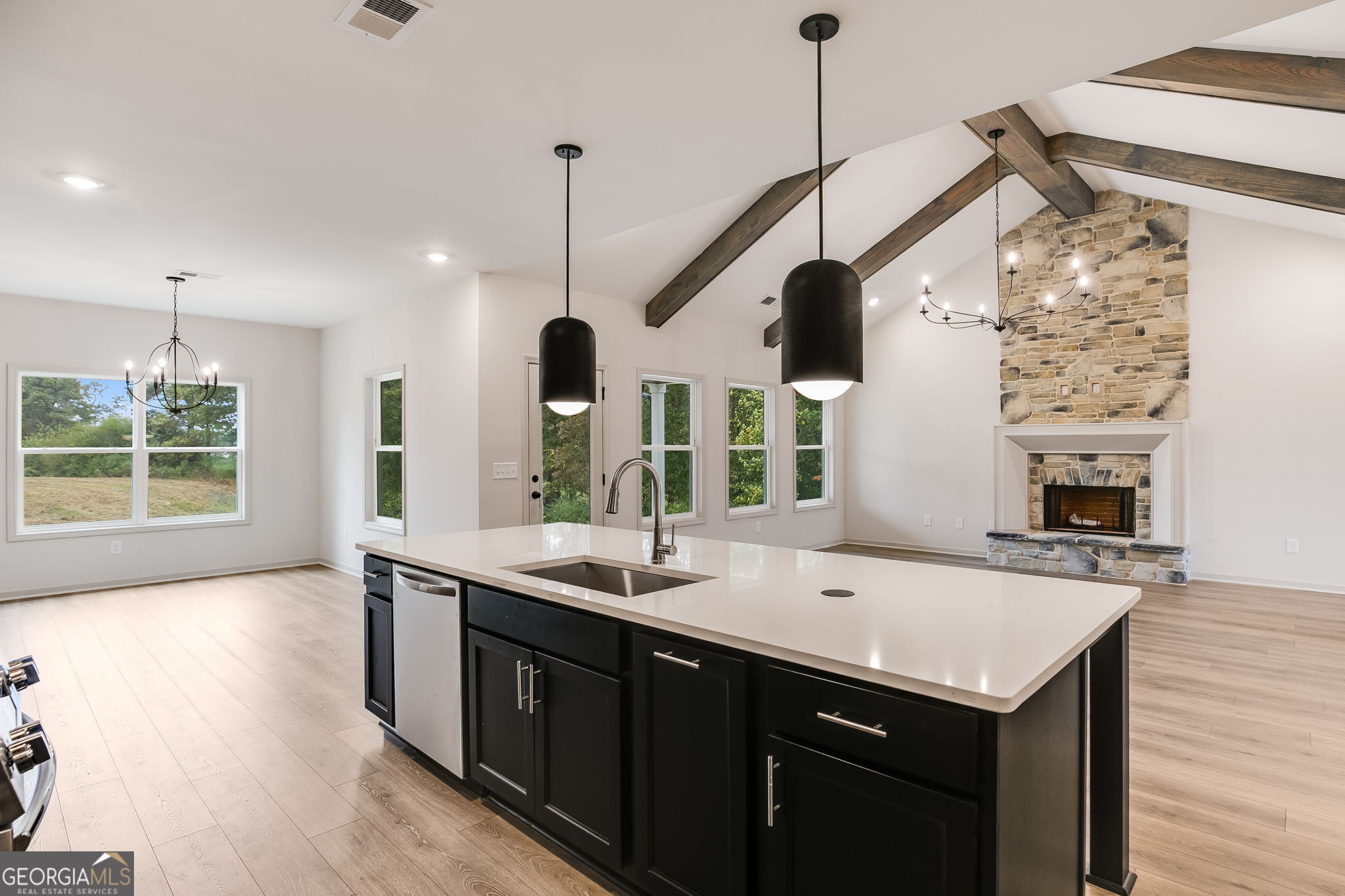 3262 Veal Road Roopville, GA 30170 - Photo 21 of 46 a kitchen with stainless steel appliances kitchen island a large island in the center and wooden floor