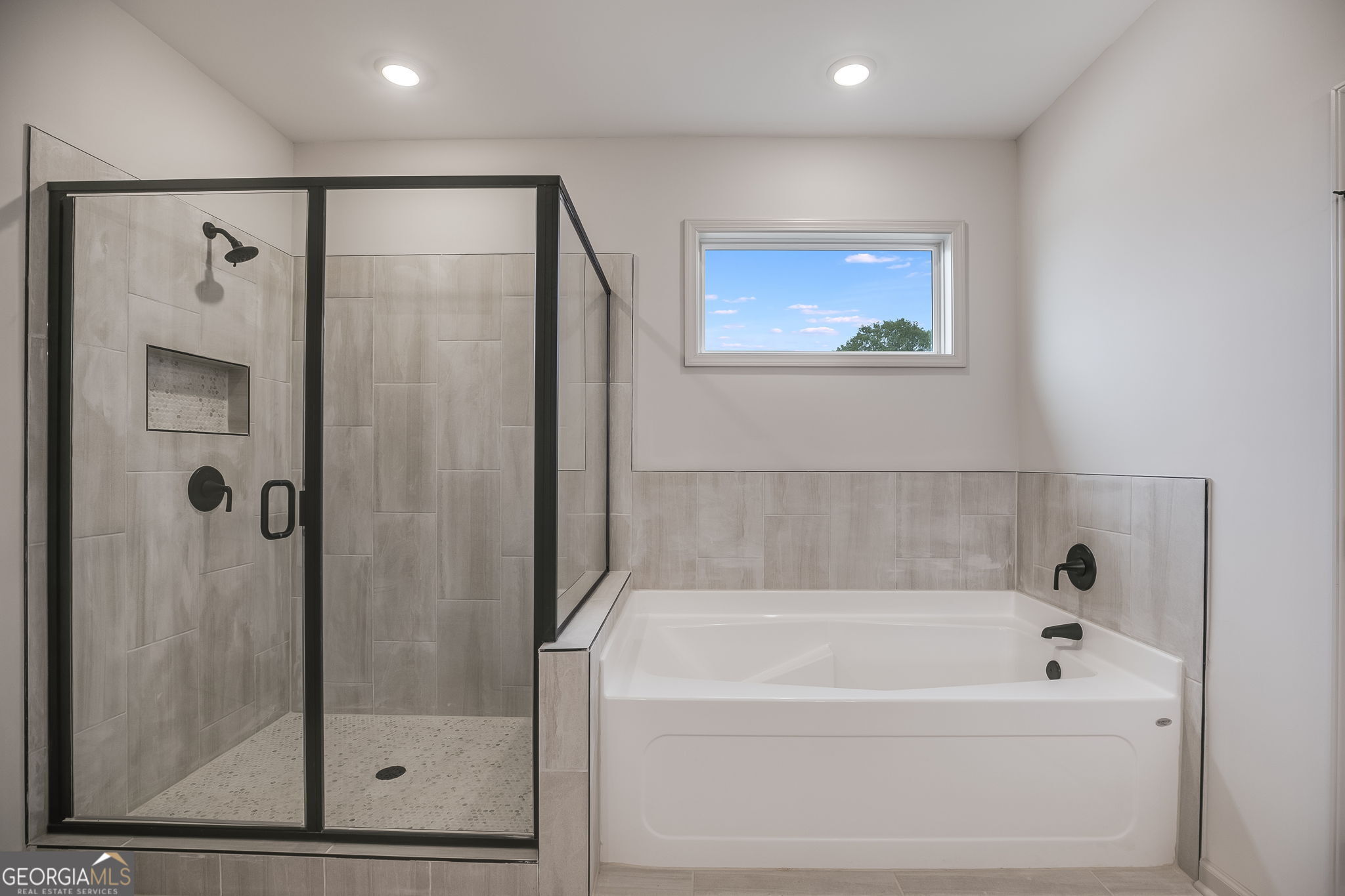 3262 Veal Road Roopville, GA 30170 - Photo 28 of 46 a bathroom with a bathtub and a shower