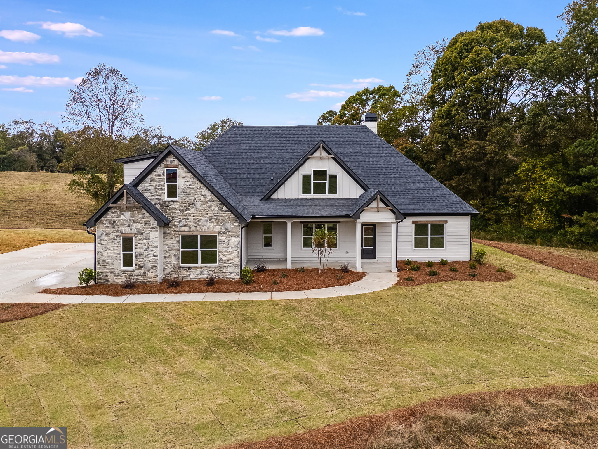 3262 Veal Road Roopville, GA 30170 - Photo 3 of 46 a front view of a house with a yard and garage