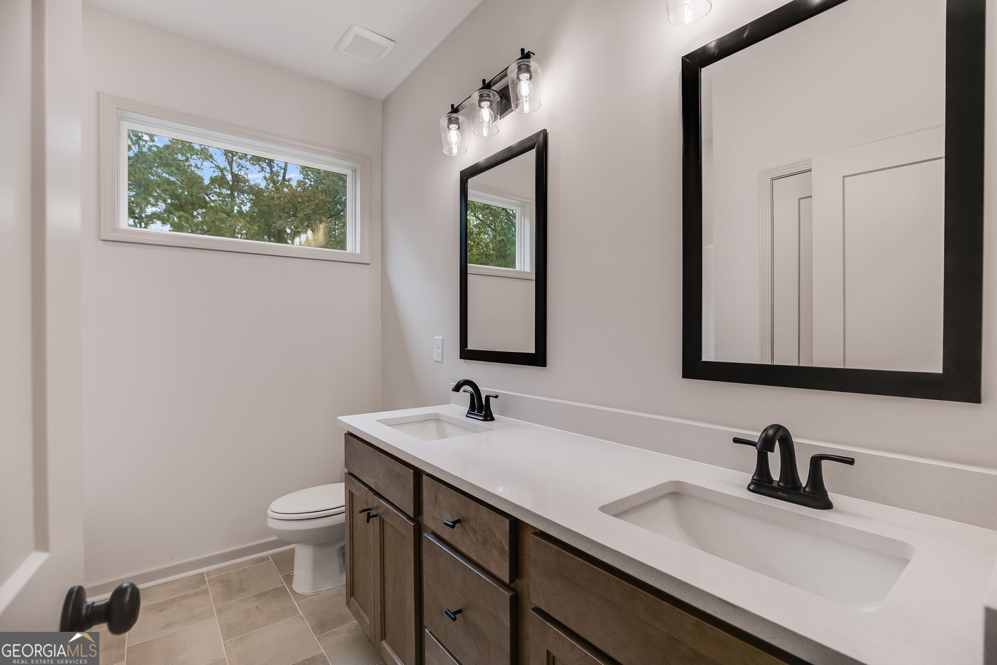 3262 Veal Road Roopville, GA 30170 - Photo 33 of 46 a bathroom with 2 sink and a mirror