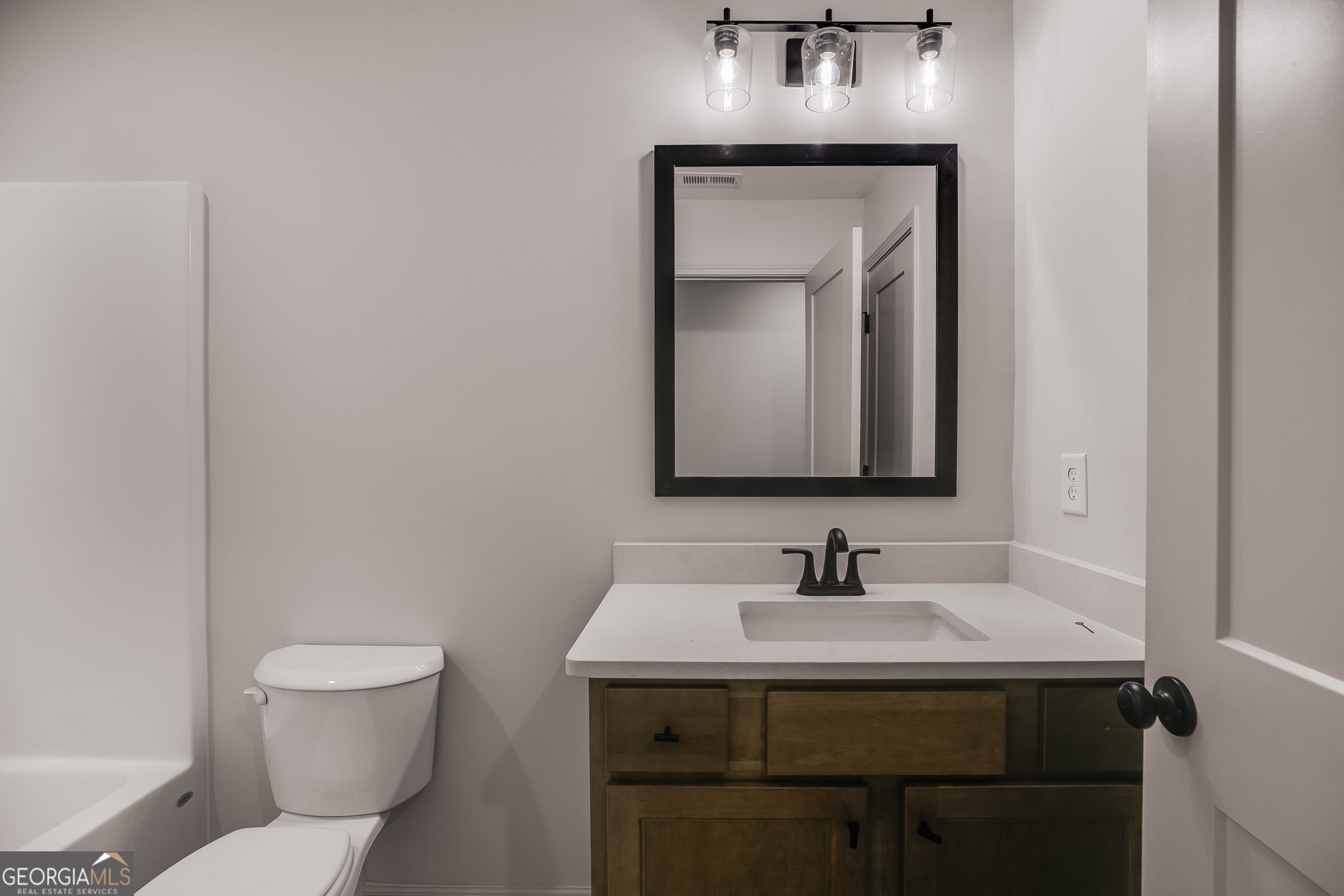 3262 Veal Road Roopville, GA 30170 - Photo 37 of 46 a bathroom with a toilet sink and mirror