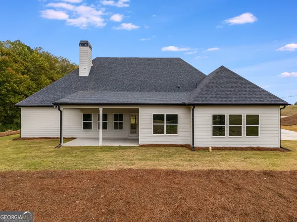 a view of a white house with large windows
