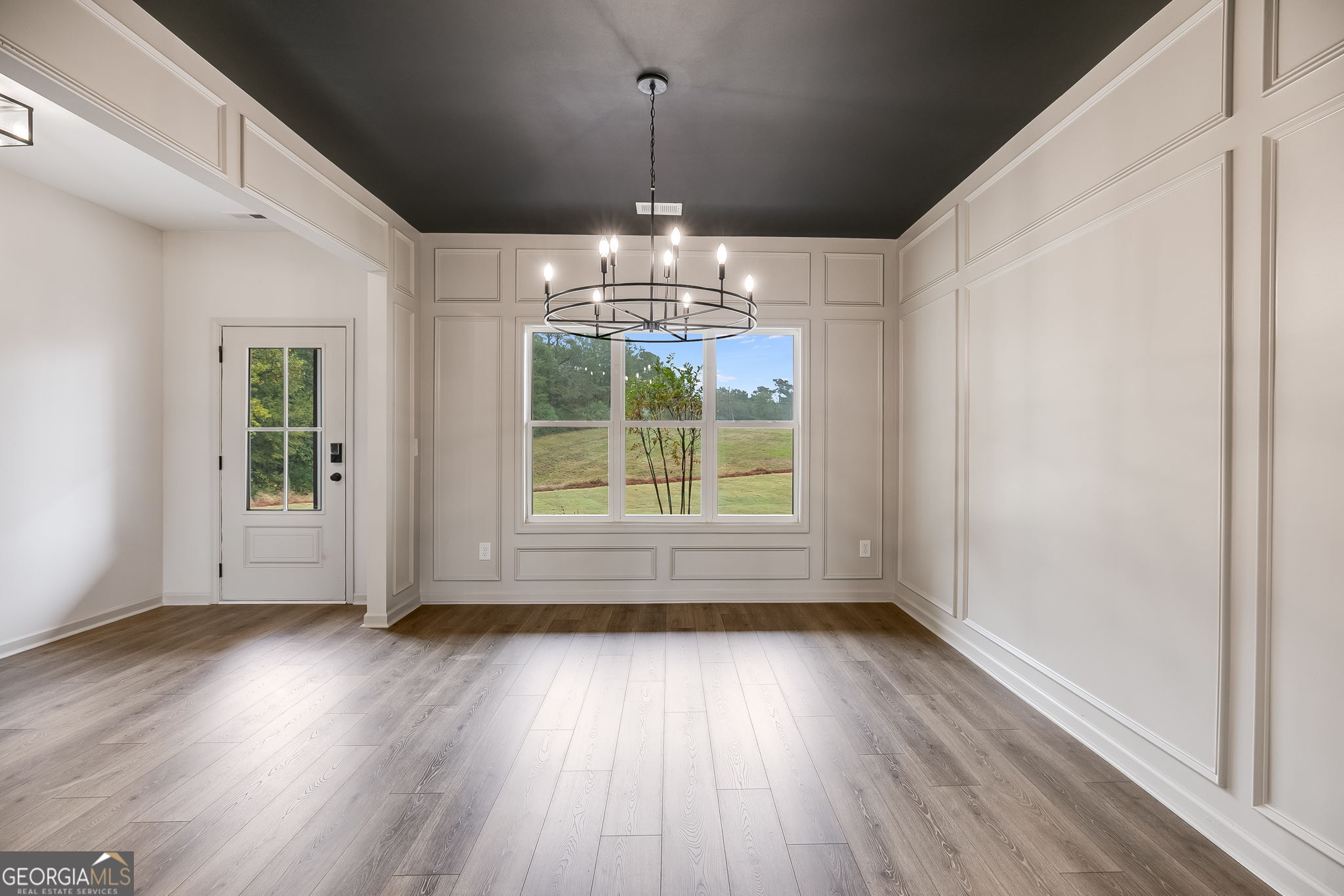 3262 Veal Road Roopville, GA 30170 - Photo 8 of 46 a view of a room with wooden floor chandeliers and kitchen view