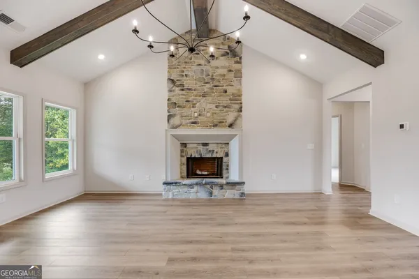 a view of a kitchen with sink microwave and cabinets