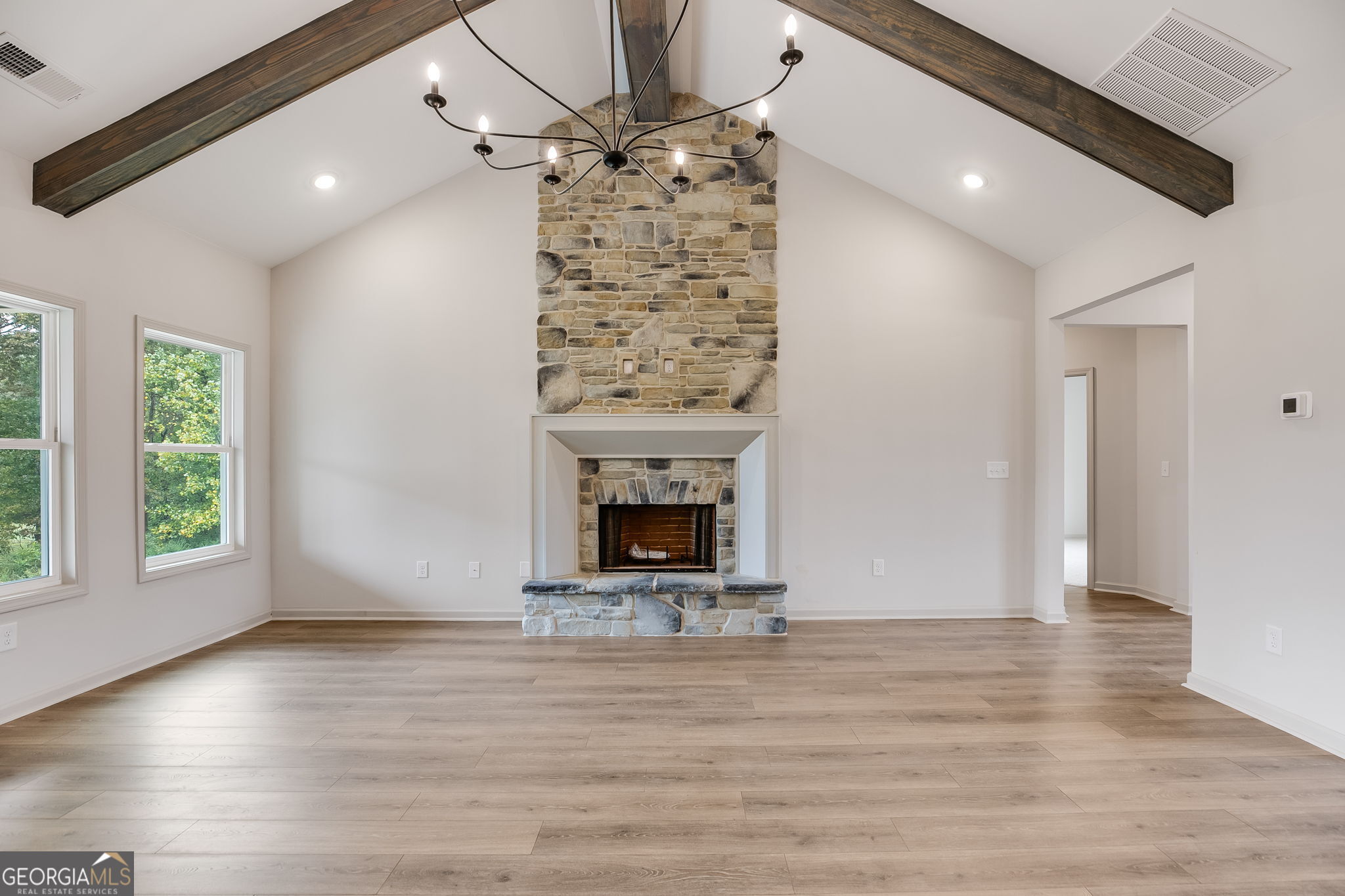 3262 Veal Road Roopville, GA 30170 - Photo 10 of 46 a view of a livingroom with wooden floor a fireplace and window