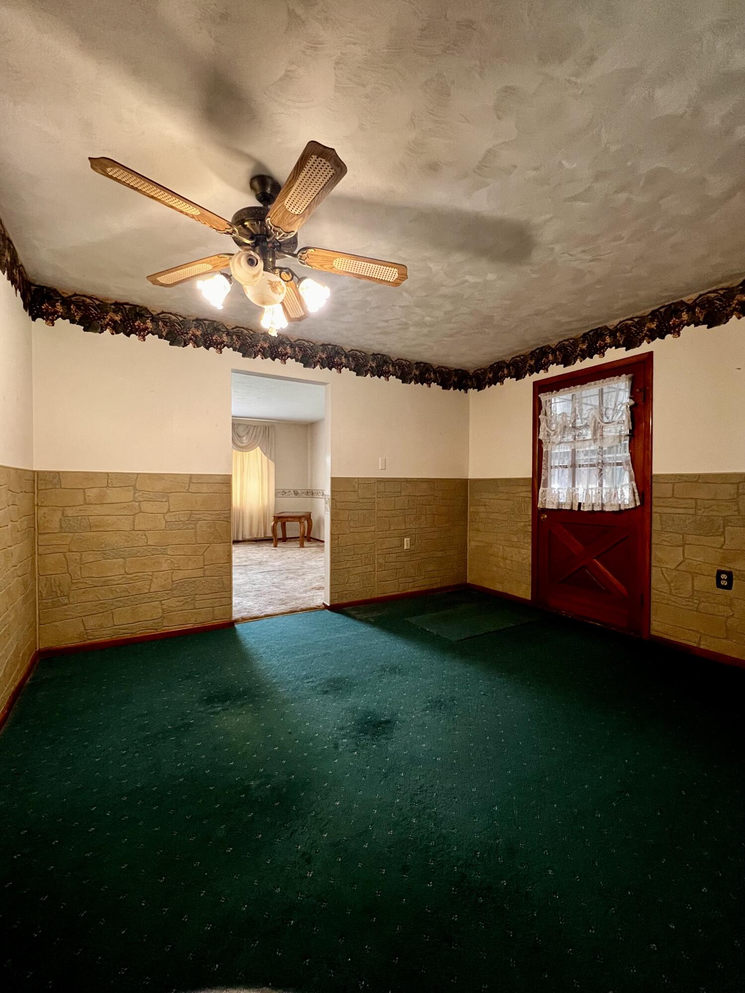 772 Imperial Road Valparaiso, IN 46385 - Photo 5 of 20 a view of an empty room and kitchen with a fan