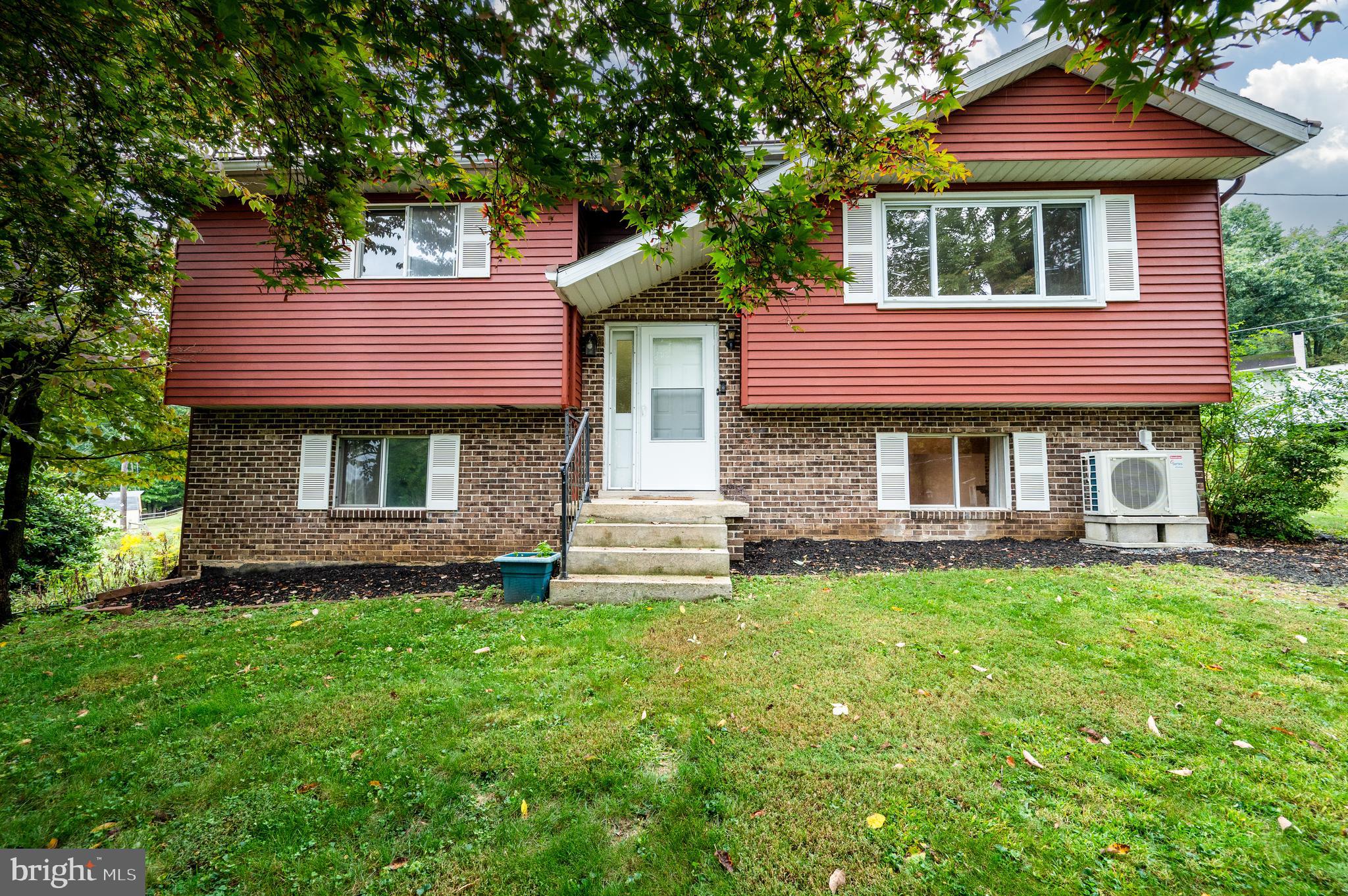 1029 Crestview Avenue Reading, PA 19607 - Photo 1 of 44 a front view of a house with a garden