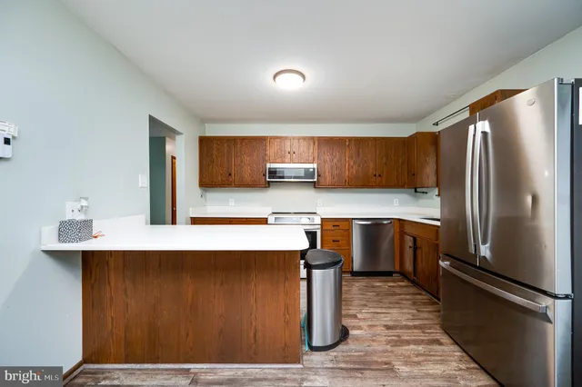 a kitchen with stainless steel appliances a refrigerator and a sink