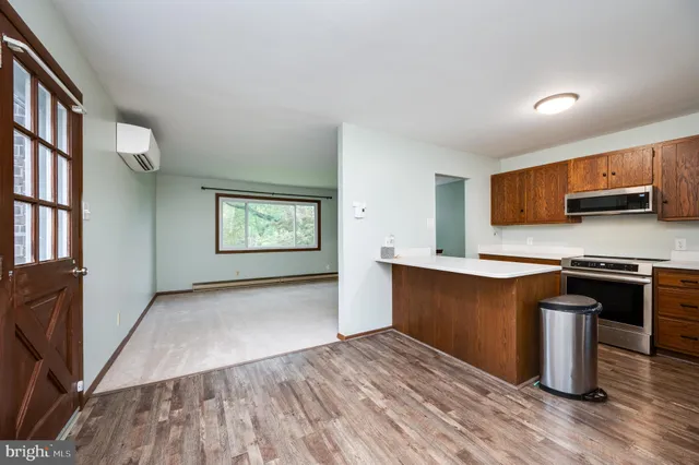 a kitchen with stainless steel appliances granite countertop a stove a sink and a refrigerator