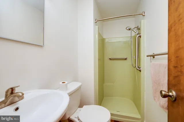 a white toilet sitting next to a bathroom sink