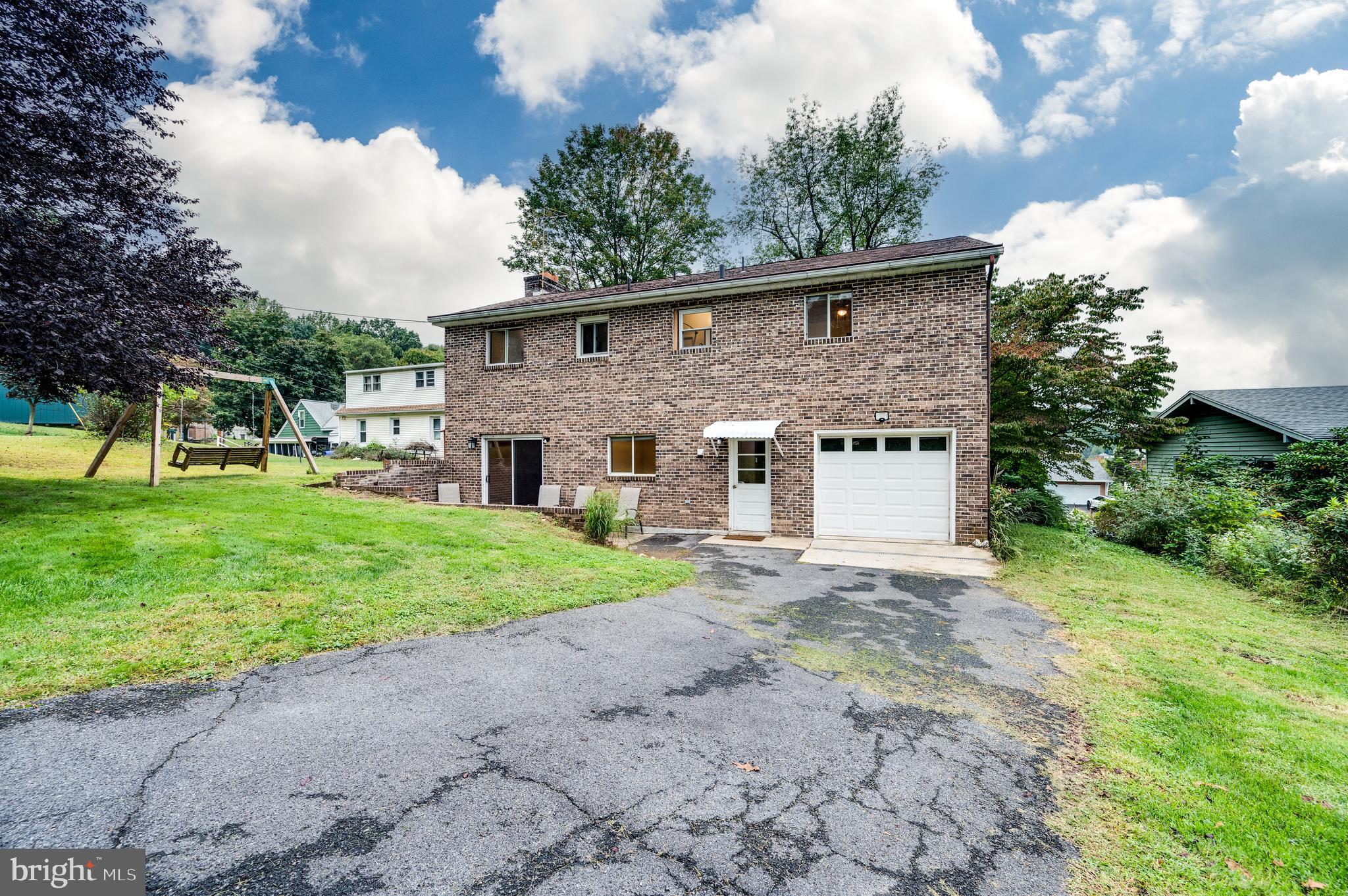 1029 Crestview Avenue Reading, PA 19607 - Photo 36 of 44 a view of a yard in front of a house with plants and large trees