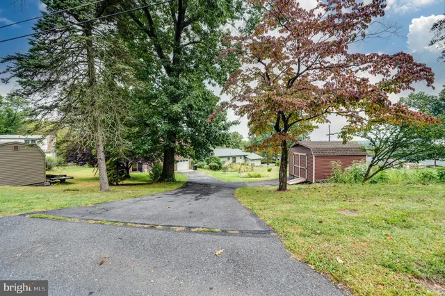 a yellow house with trees in front of it