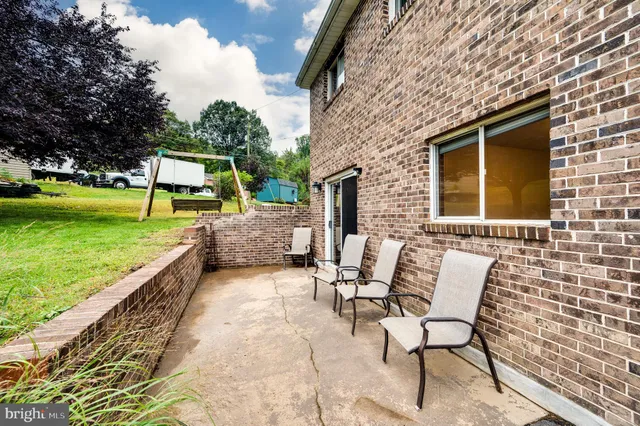 a view of a backyard with sitting area