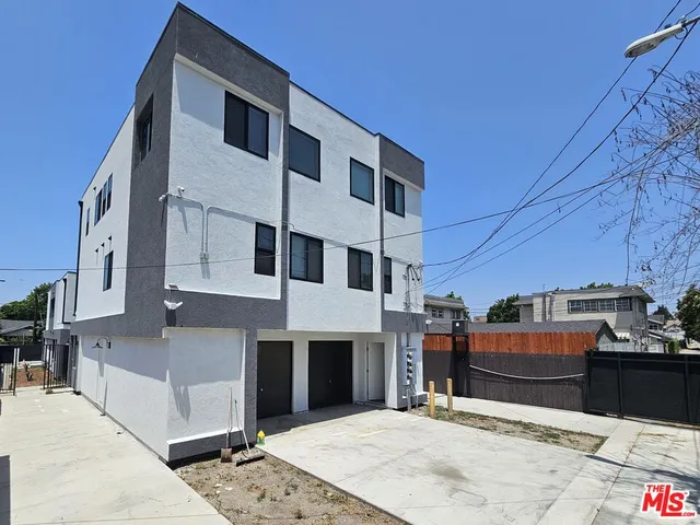 a front view of a building with parking space