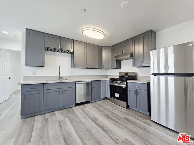 a kitchen with granite countertop stainless steel appliances and wooden cabinets