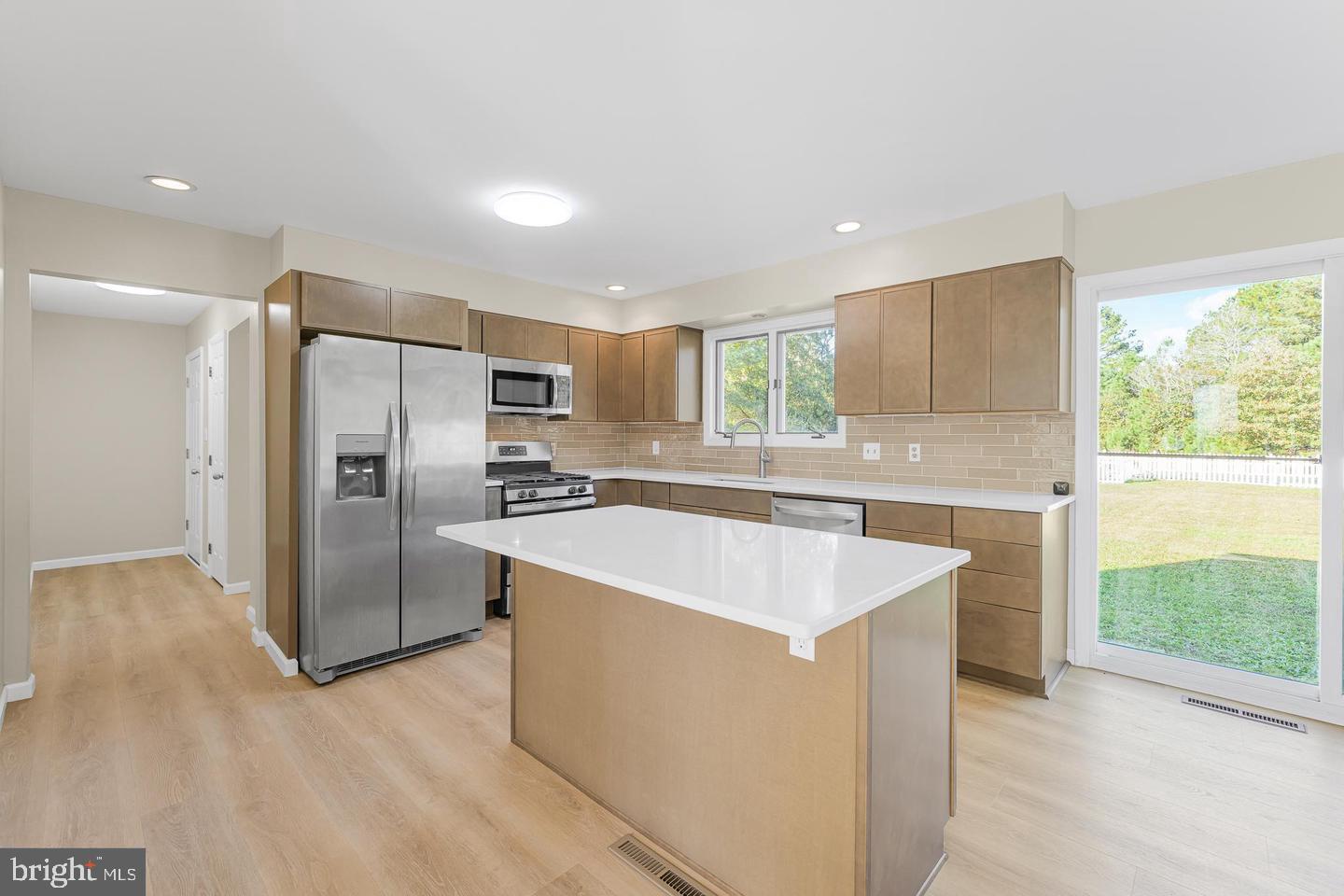 15250 Hudson Road Milton, DE 19968 - Photo 19 of 64 a large kitchen with stainless steel appliances kitchen island a large counter top and a refrigerator