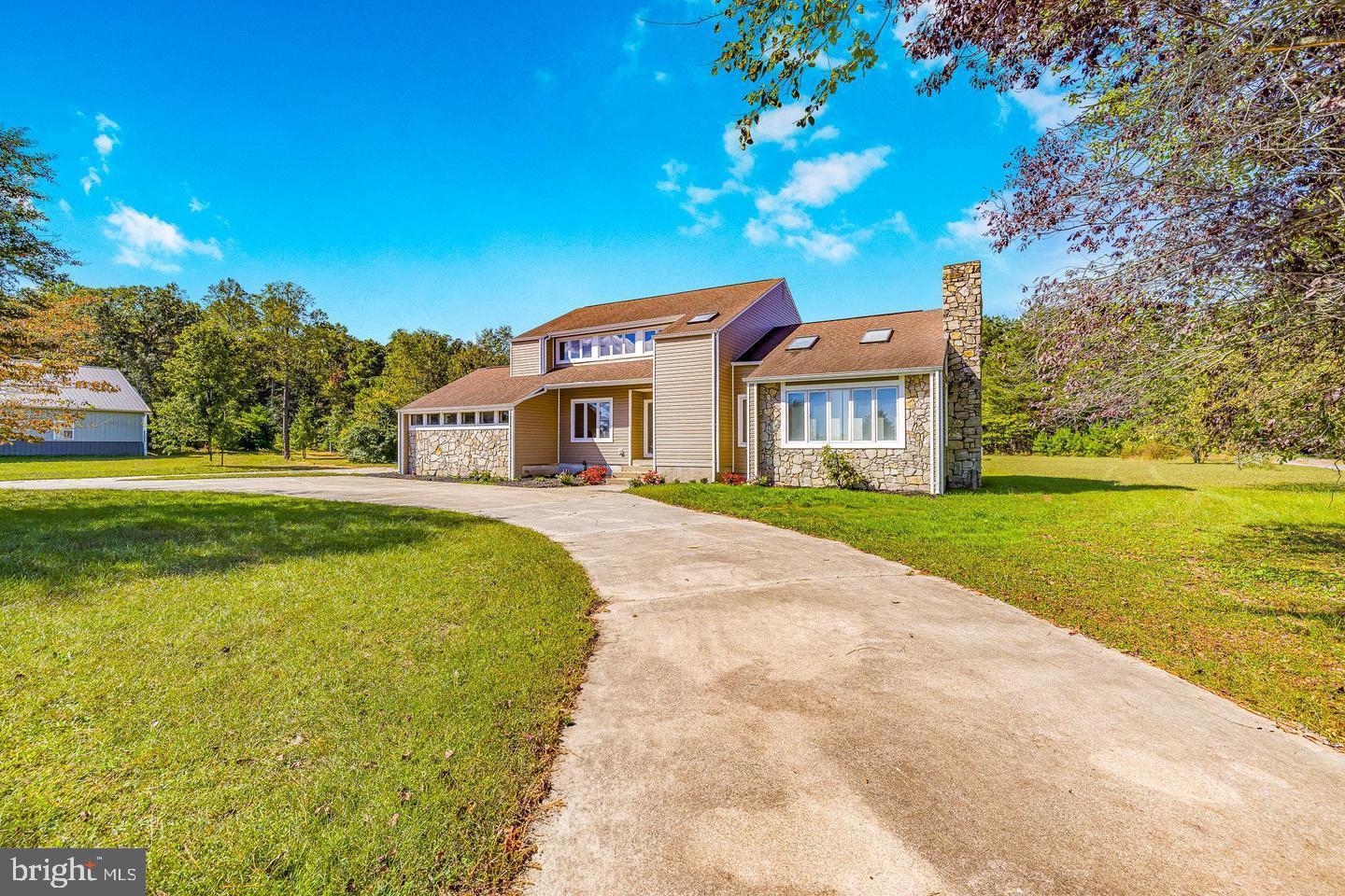 15250 Hudson Road Milton, DE 19968 - Photo 5 of 64 a front view of a house with a garden and yard