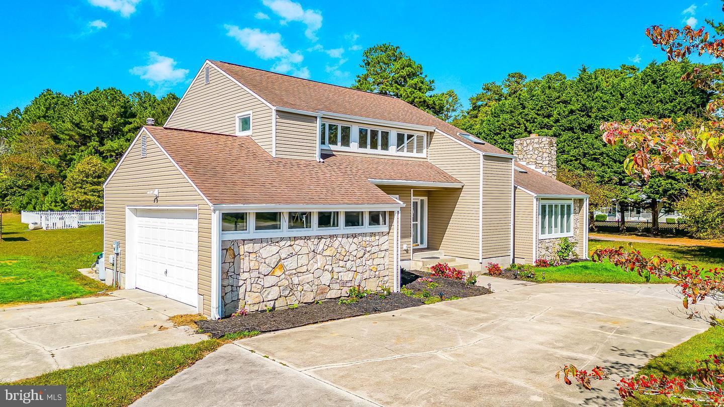 15250 Hudson Road Milton, DE 19968 - Photo 7 of 64 a front view of a house with garden