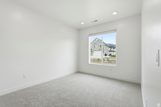 401 West 3085 South, Unit 329 Nibley, UT 84321 - Photo 19 of 34 Empty room with light colored carpet and recessed lighting
