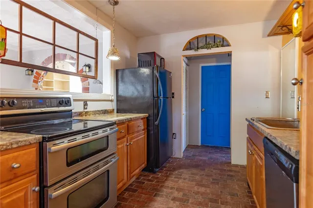 a kitchen with stainless steel appliances granite countertop a stove and a refrigerator