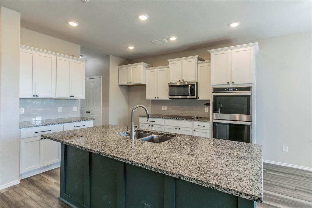 6401 Elephant Butte Drive Waco, TX 76708 - Photo 9 of 34 a kitchen with stainless steel appliances granite countertop a sink stove and oven